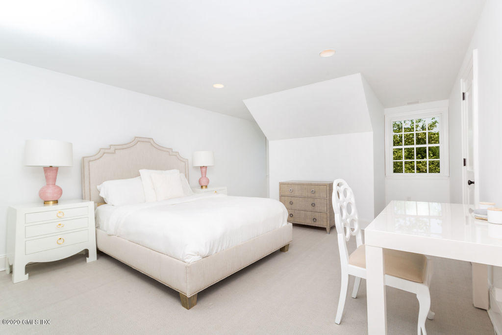 14 Dingletown Road Greenwich, CT 06830 - Photo 34 of 56 a bedroom with a bed a table and a dresser