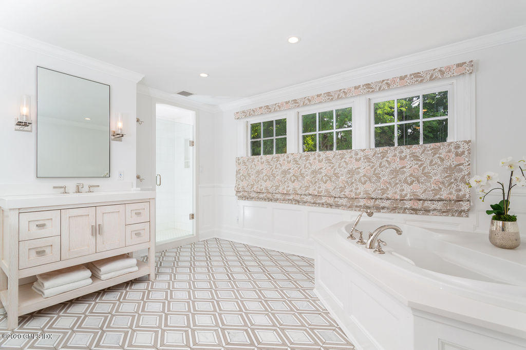 14 Dingletown Road Greenwich, CT 06830 - Photo 40 of 56 a bathroom with a tub sink and mirror