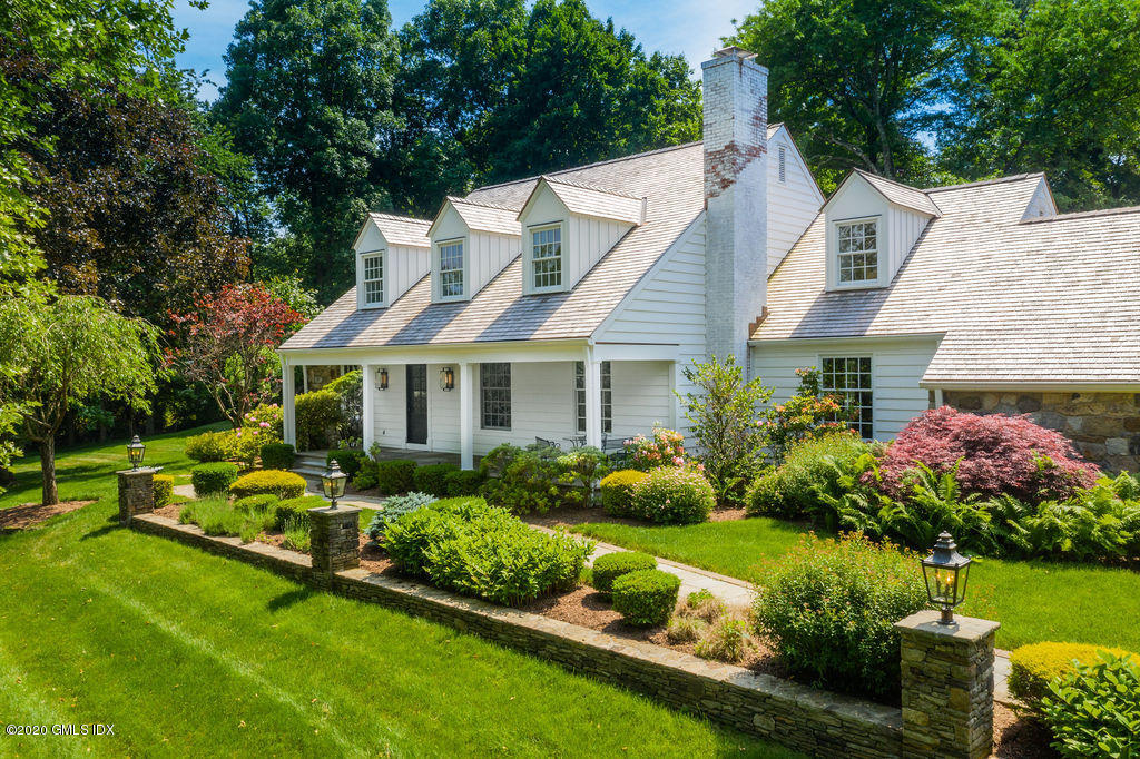 14 Dingletown Road Greenwich, CT 06830 - Photo 4 of 56 a view of a white house with a big yard and potted plants