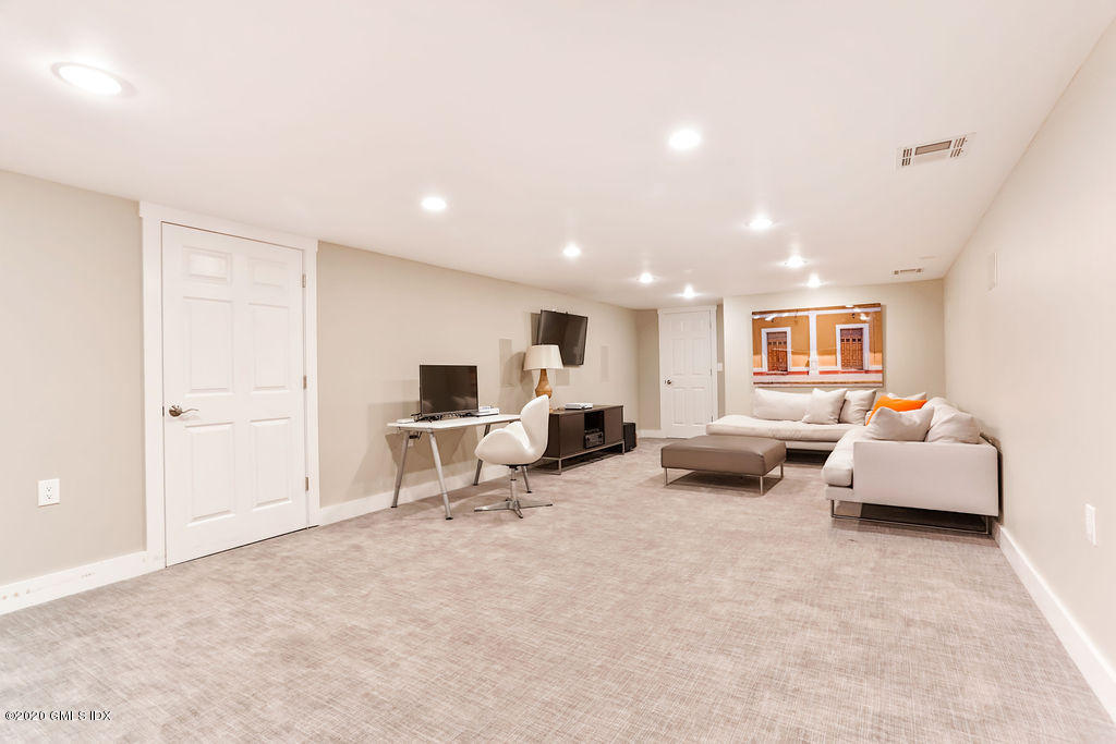 14 Dingletown Road Greenwich, CT 06830 - Photo 42 of 56 a living room with furniture and a flat screen tv