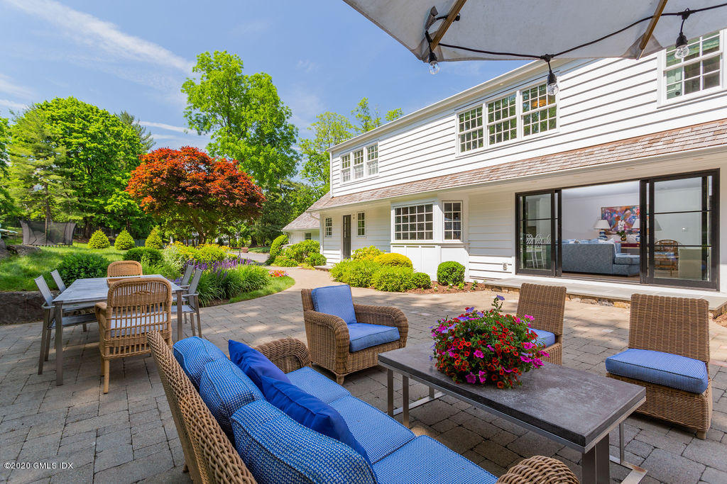 14 Dingletown Road Greenwich, CT 06830 - Photo 46 of 56 a view of a patio with couches table and chairs and potted plants