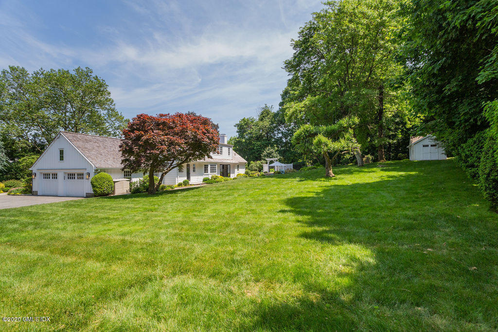 14 Dingletown Road Greenwich, CT 06830 - Photo 56 of 56 a front view of a house with a yard and trees