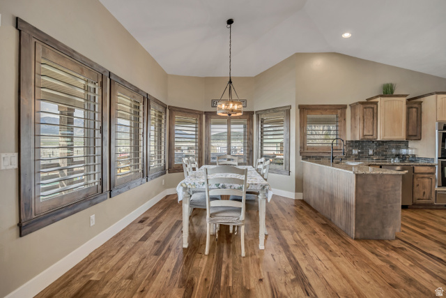 3054 West Ridgeline Road Stockton, UT 84071 - Photo 40 of 88 Dining room featuring dark wood-style floors, lofted ceiling, and suspended lighting