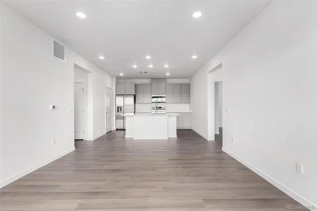 a view of kitchen view wooden cabinets and wooden floor