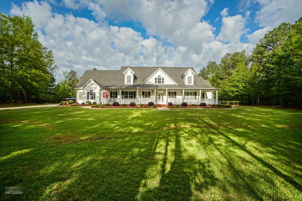 130 Orchard Ridge Drive Forsyth, GA 31029 - Photo 2 of 24 a front view of a house with garden