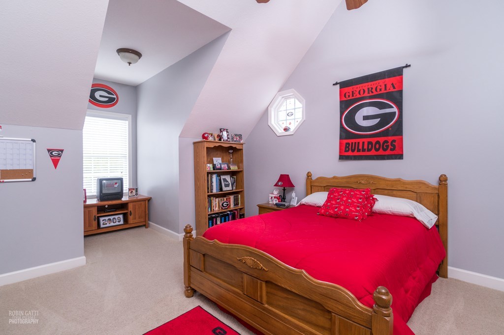 130 Orchard Ridge Drive Forsyth, GA 31029 - Photo 16 of 24 a bedroom with a bed and a dresser
