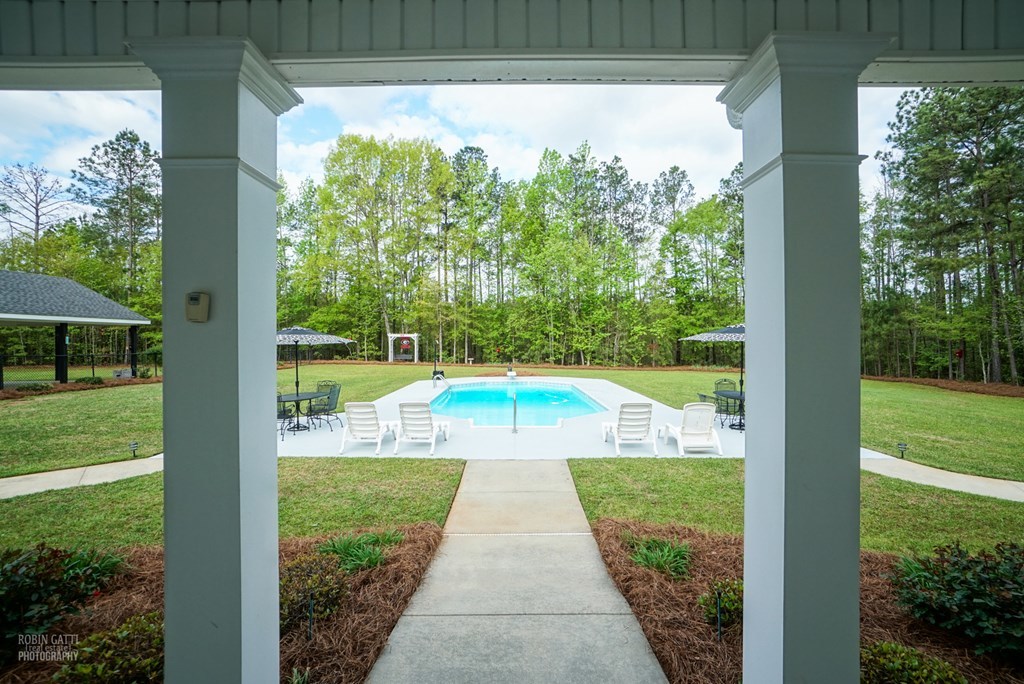 130 Orchard Ridge Drive Forsyth, GA 31029 - Photo 20 of 24 a view of a swimming pool with a yard