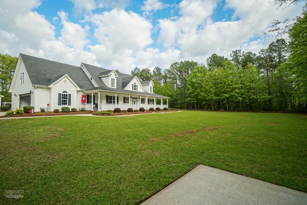 130 Orchard Ridge Drive Forsyth, GA 31029 - Photo 3 of 24 a view of house that has a lot of big trees