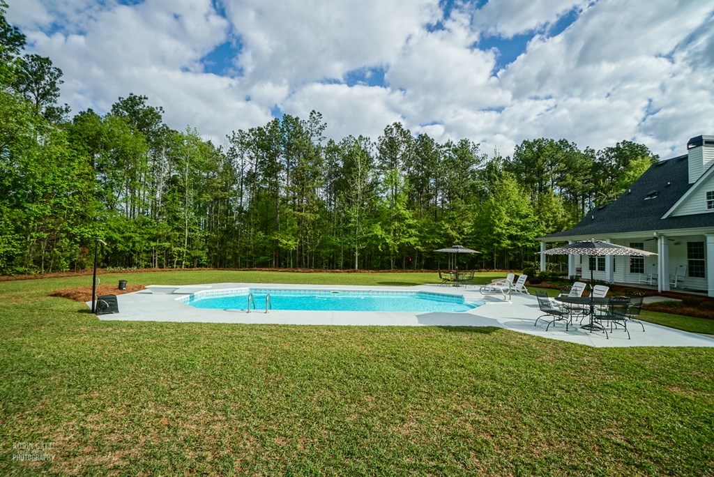 130 Orchard Ridge Drive Forsyth, GA 31029 - Photo 23 of 24 a view of a swimming pool with a table and chairs