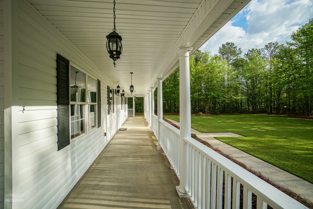130 Orchard Ridge Drive Forsyth, GA 31029 - Photo 4 of 24 a view of a porch with wooden floor and outdoor space