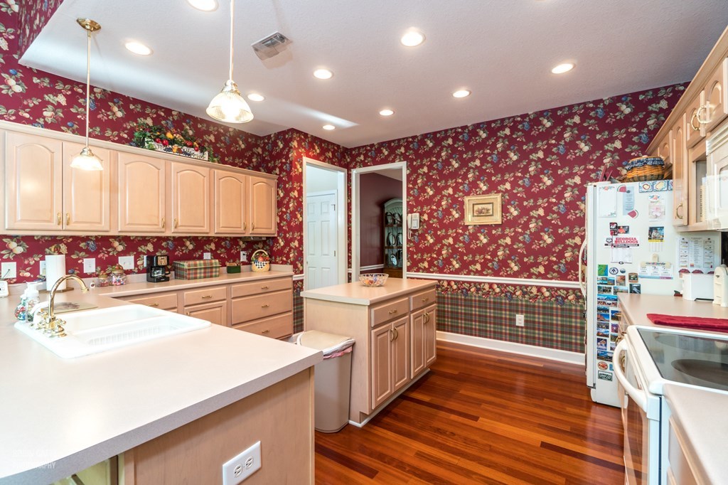 130 Orchard Ridge Drive Forsyth, GA 31029 - Photo 7 of 24 a kitchen with stainless steel appliances kitchen island granite countertop a sink and cabinets