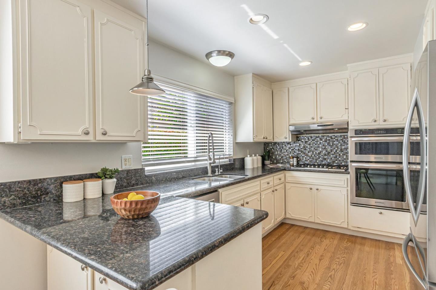 824 Buchser Way San Jose, CA 95125 - Photo 14 of 50 a kitchen with stainless steel appliances granite countertop a sink and a white cabinets