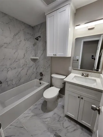a bathroom with a sink toilet and bathtub