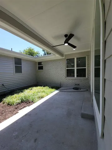 a view of a house with backyard and porch