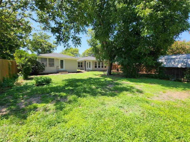 a view of a house with a yard porch and sitting area