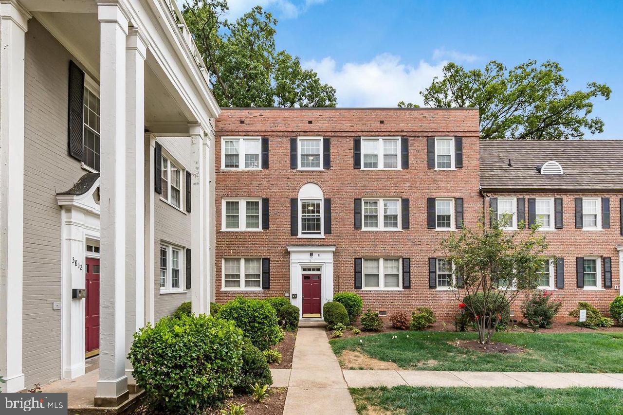 a front view of a residential apartment building with a yard