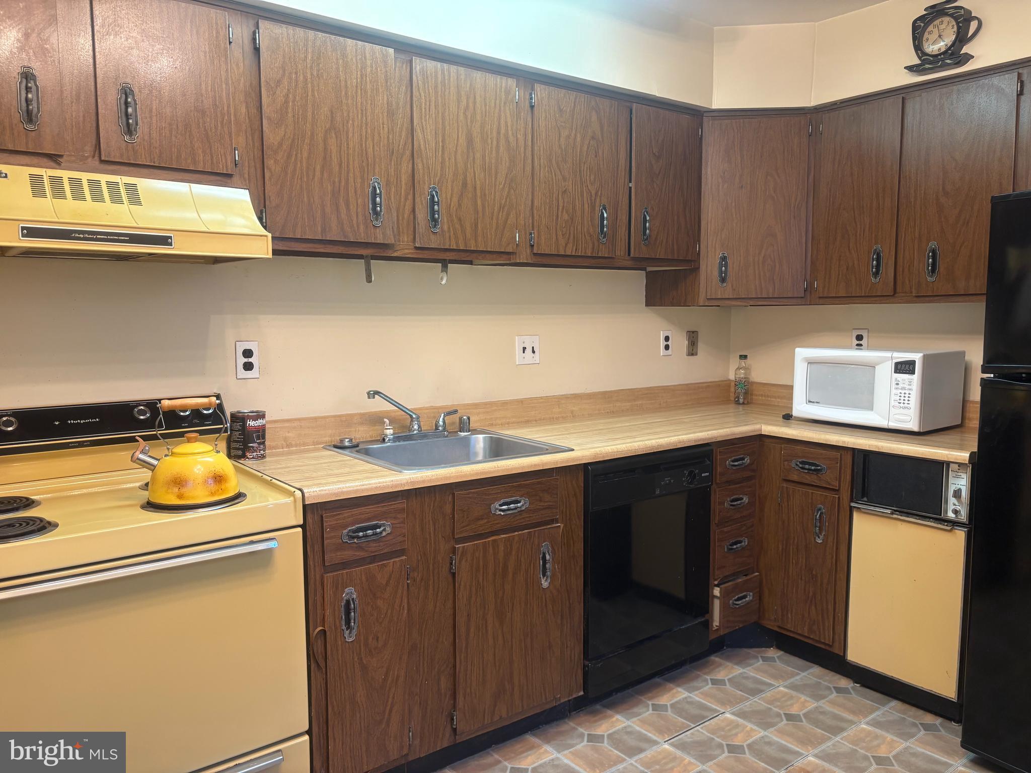 2107 Fort Davis Street Southeast, Unit 202 Washington, DC 20020 - Photo 2 of 7 a kitchen with a sink and cabinets
