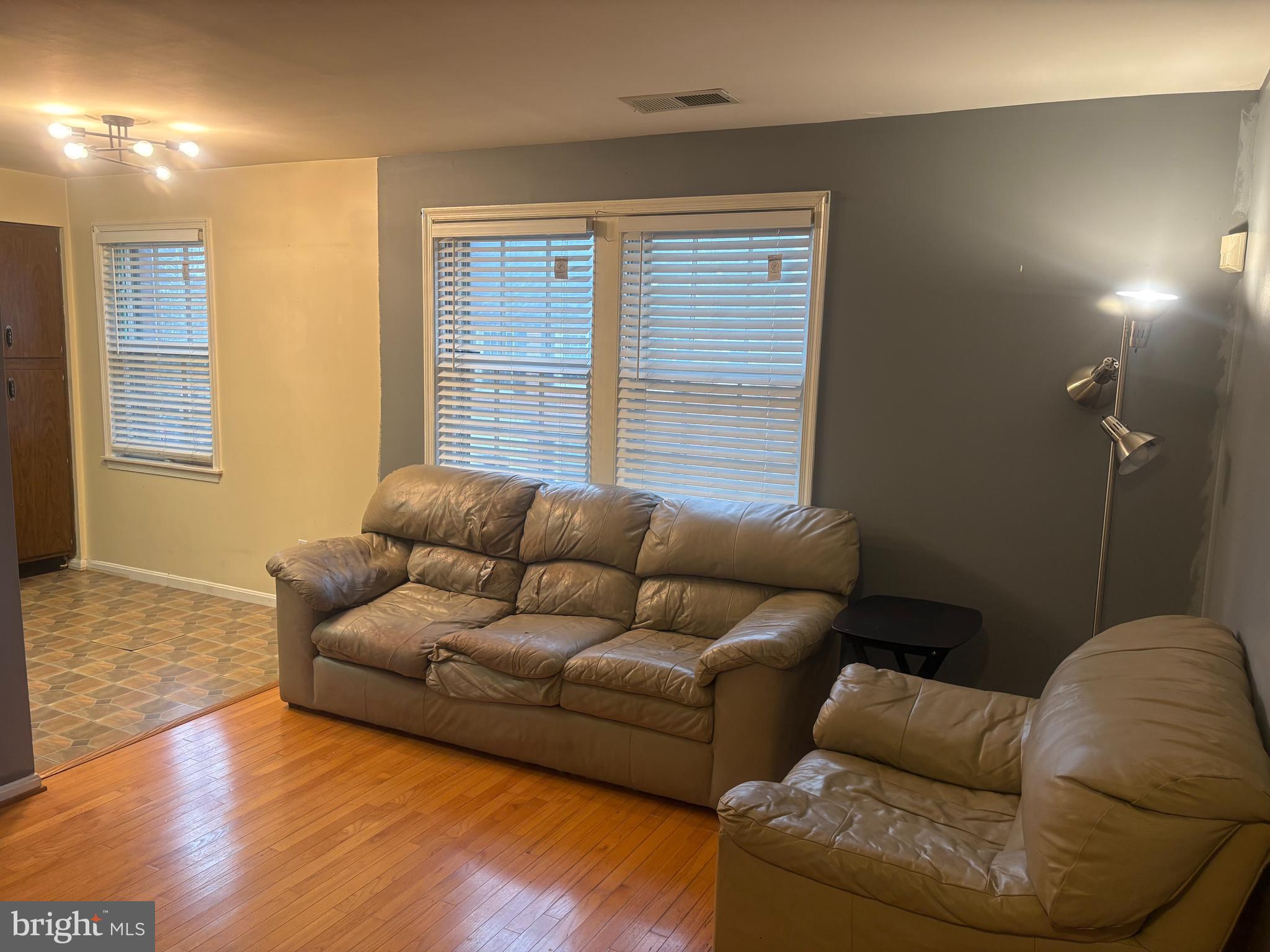2107 Fort Davis Street Southeast, Unit 202 Washington, DC 20020 - Photo 3 of 7 a living room with furniture window and a wooden floor
