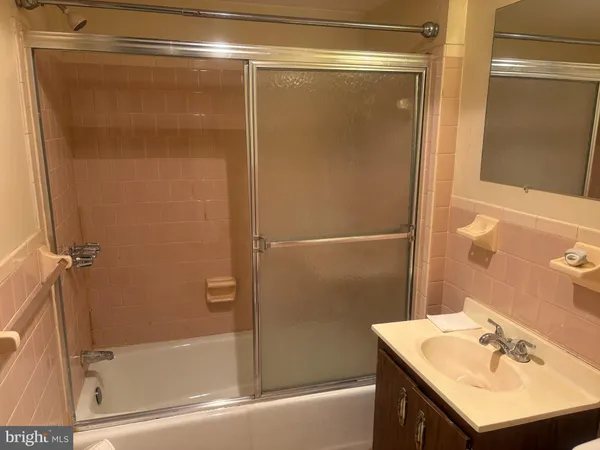 a bathroom with a shower and a sink