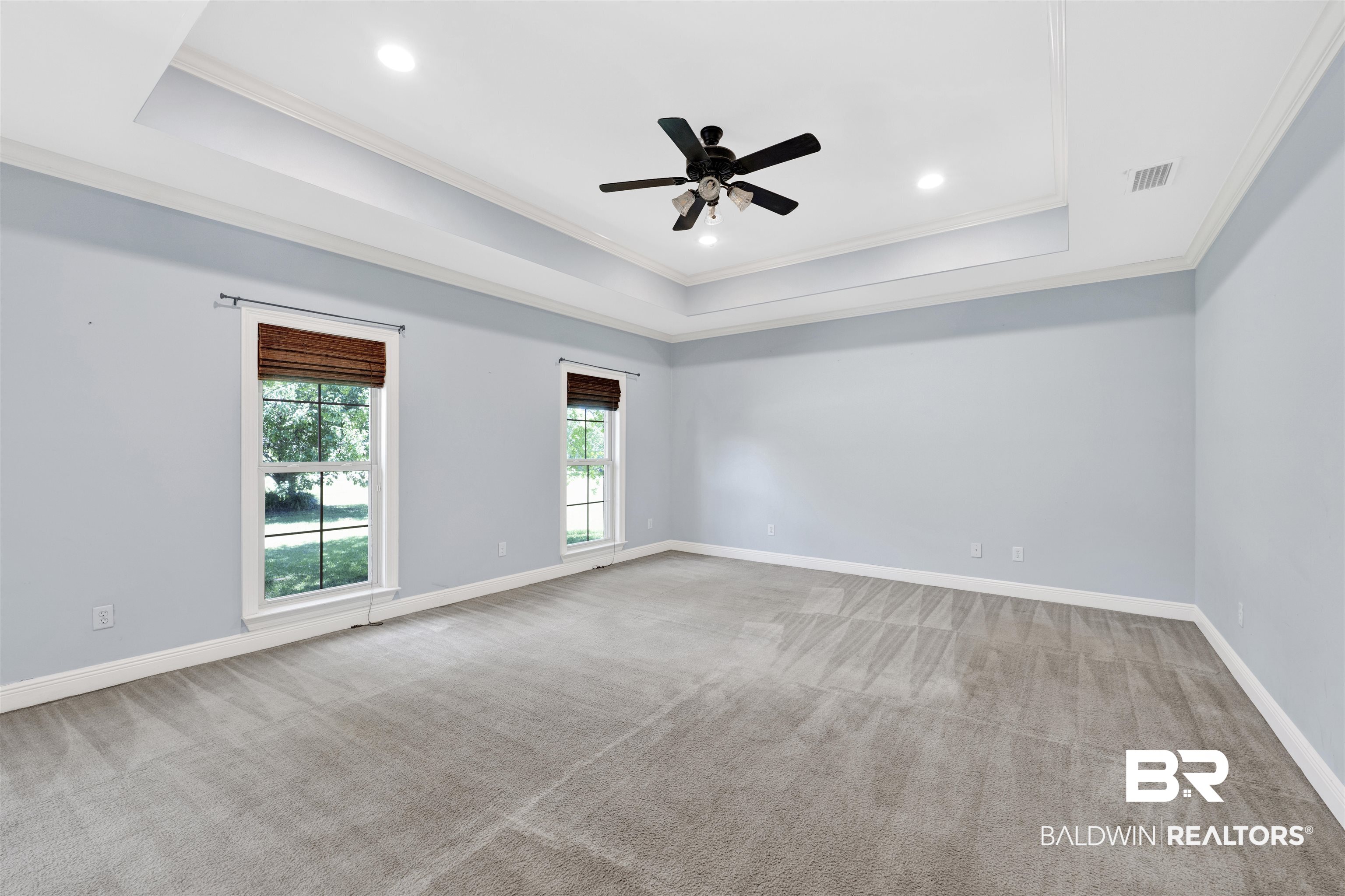 12944 Anna's Way Stapleton, AL 36578 - Photo 49 of 64 Spacious room featuring a tray ceiling with crown molding, recessed lighting, and a ceiling fan