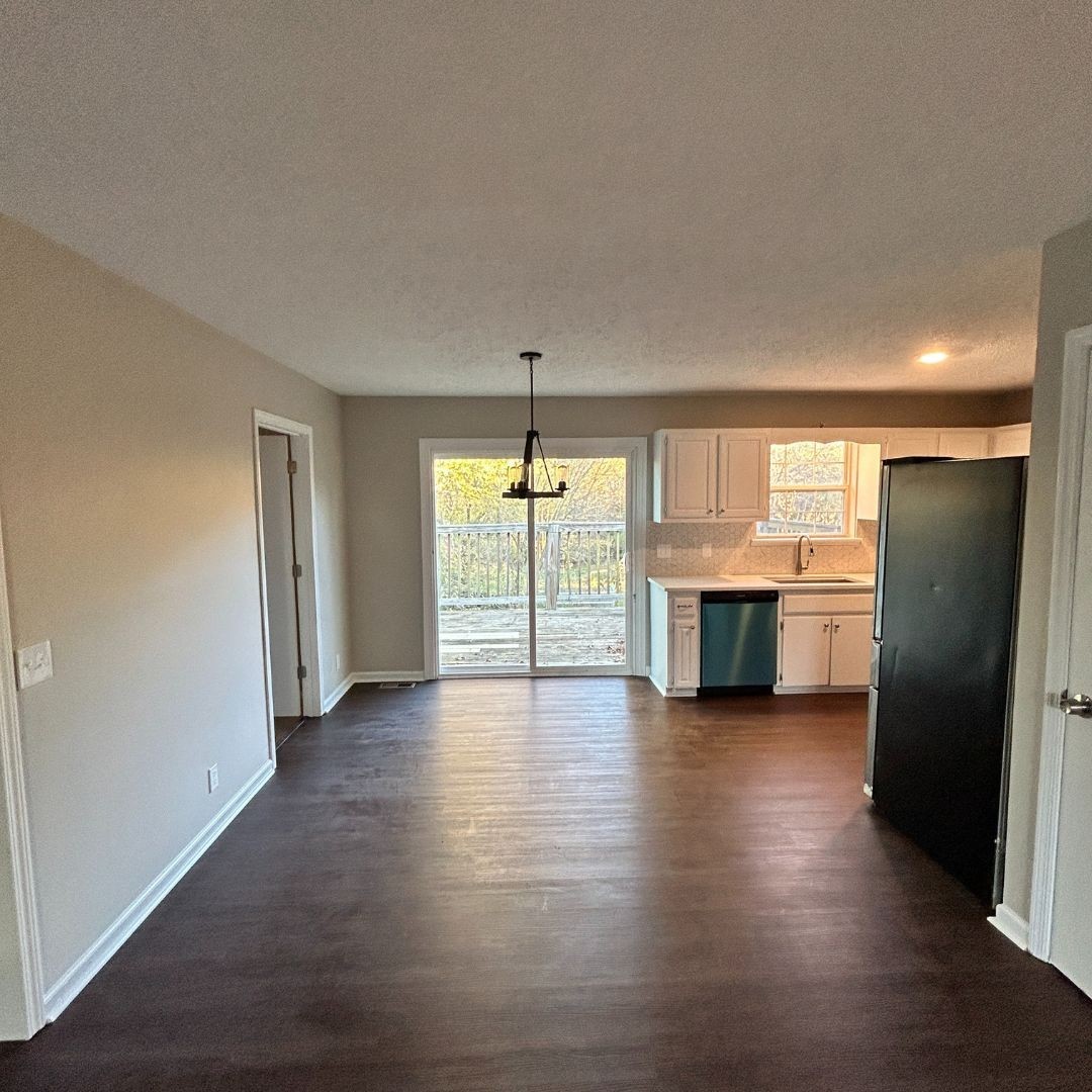646 Butler Road Portland, TN 37148 - Photo 2 of 11 a view of a kitchen with a sink and a refrigerator a cabinet mirror and window