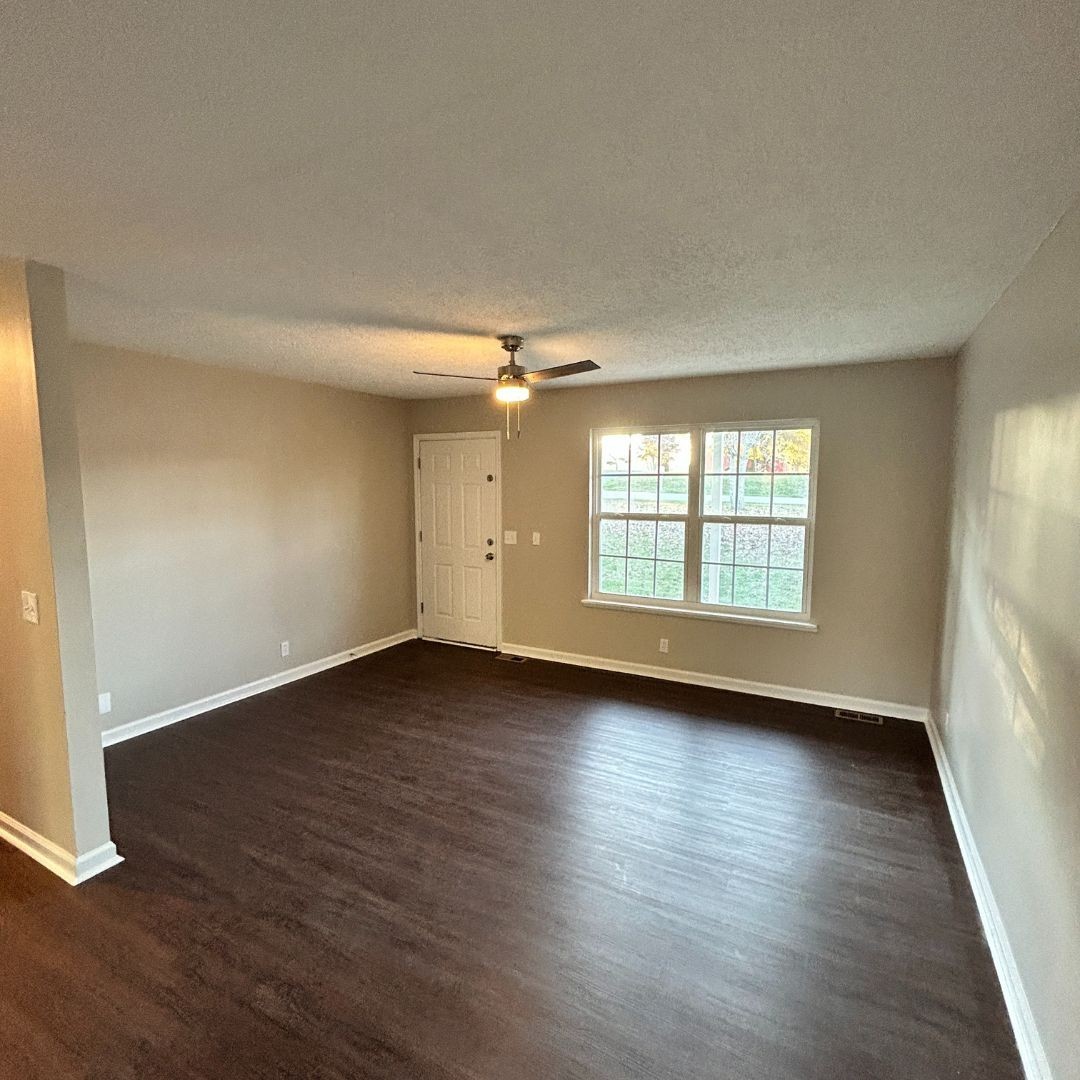 646 Butler Road Portland, TN 37148 - Photo 4 of 11 an empty room with wooden floor and windows