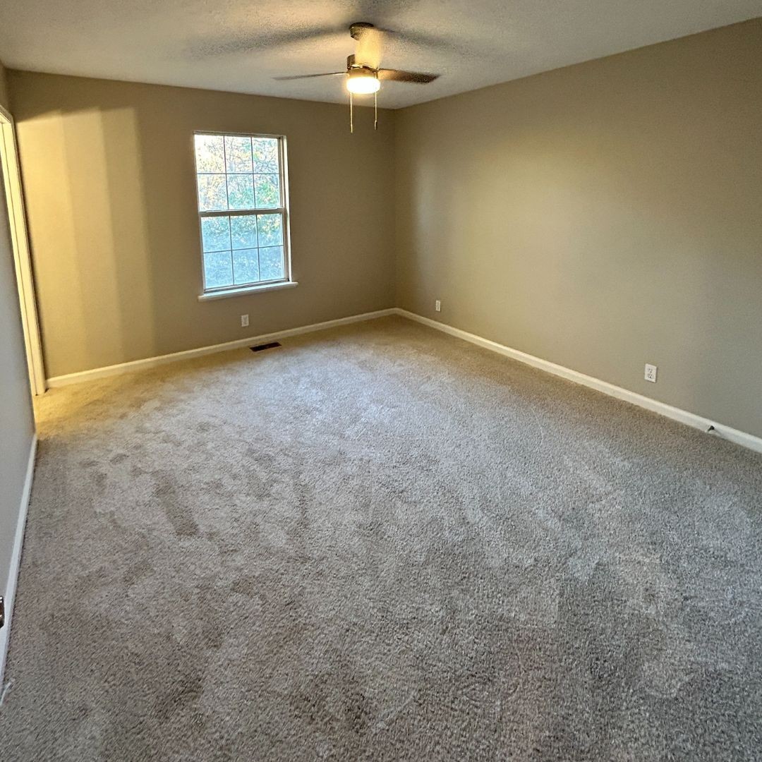 646 Butler Road Portland, TN 37148 - Photo 6 of 11 an empty room with windows and chandelier fan