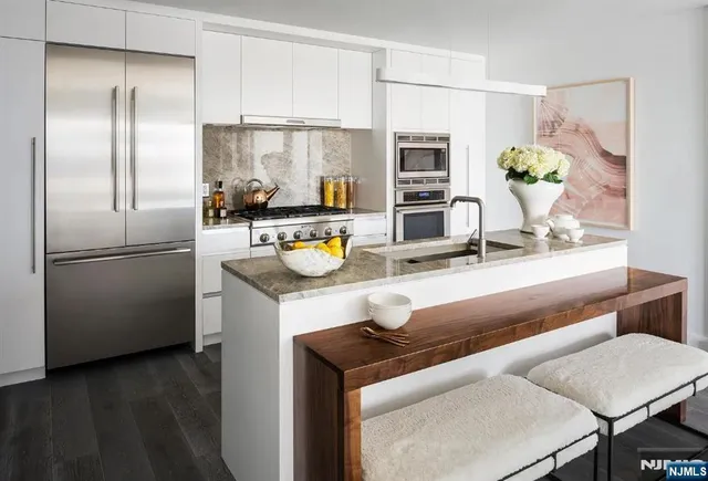 a kitchen with a refrigerator and a table