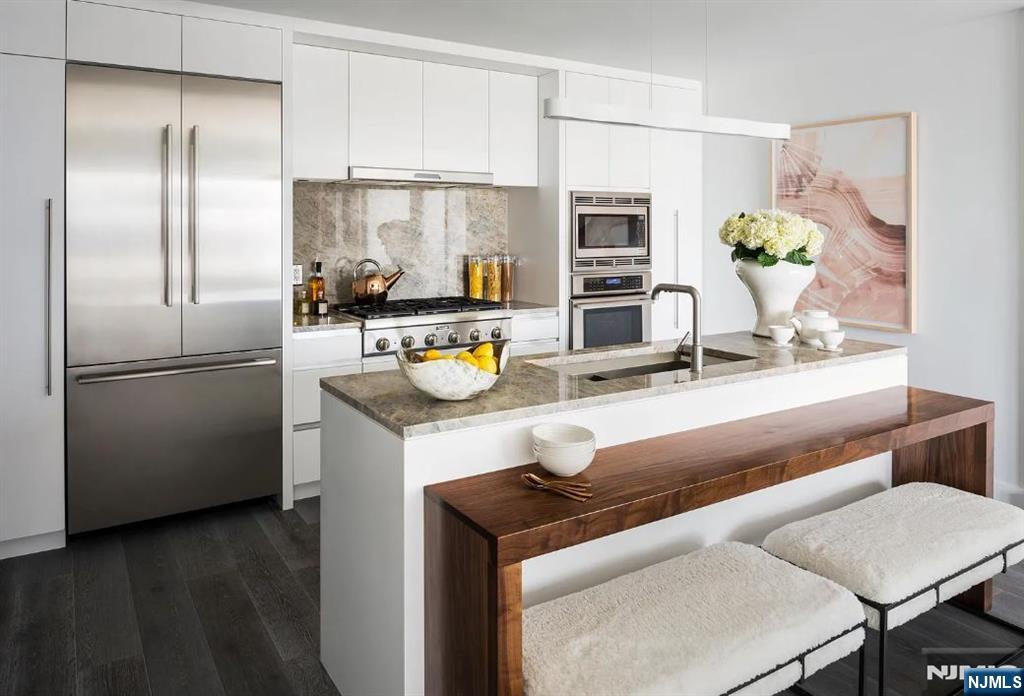 a kitchen with a refrigerator and a table