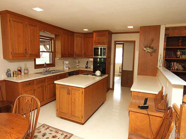 4105 Fiesta Road Durham, NC 27703 - Photo 13 of 25 a kitchen with stainless steel appliances granite countertop a sink a stove and a refrigerator