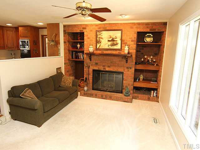 4105 Fiesta Road Durham, NC 27703 - Photo 16 of 25 a living room with furniture a fireplace and stainless steel appliances