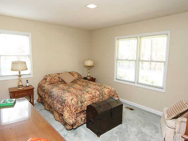 4105 Fiesta Road Durham, NC 27703 - Photo 18 of 25 a bedroom with a bed and window