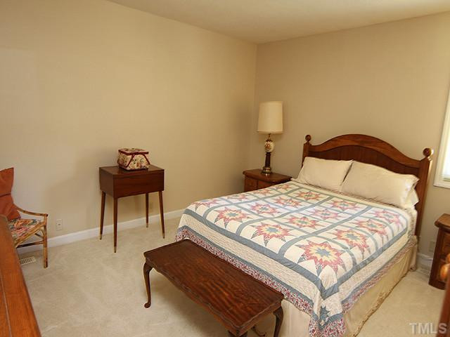 4105 Fiesta Road Durham, NC 27703 - Photo 19 of 25 a bedroom with a bed and a chair