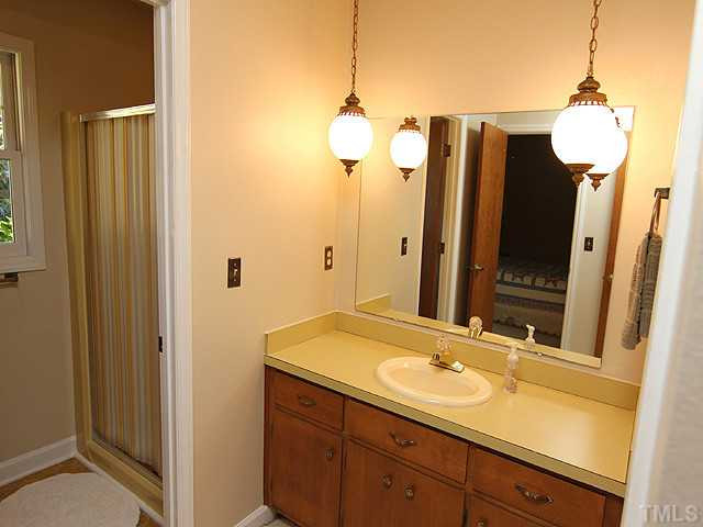 4105 Fiesta Road Durham, NC 27703 - Photo 20 of 25 a bathroom with a sink and a mirror