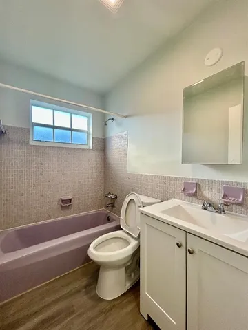 a bathroom with a toilet a sink and bathtub