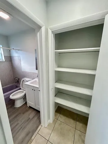 a view of bedroom with a sink and a toilet