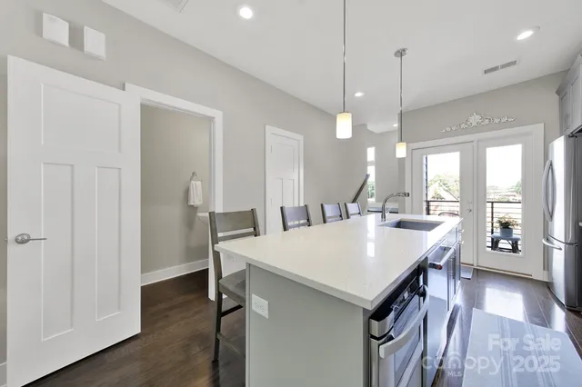 a large kitchen with a table and chairs