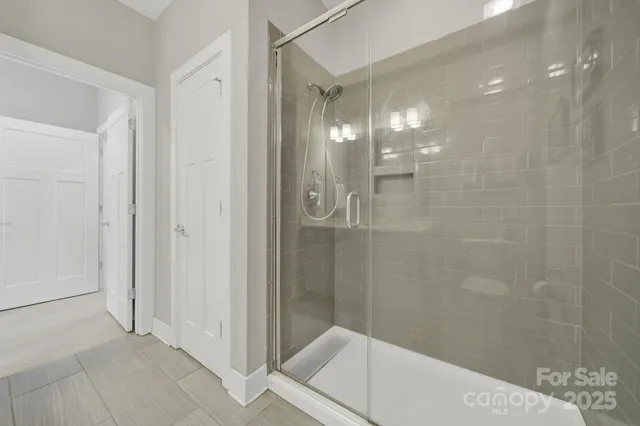 a bathroom with a glass shower door
