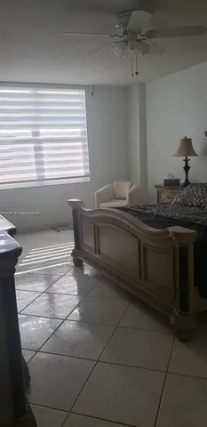 a spacious bathroom with a granite countertop sink and a bathtub