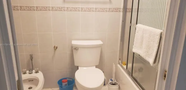 a bathroom with a glass shower door