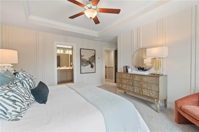 a bedroom with a bed a chandelier and dresser