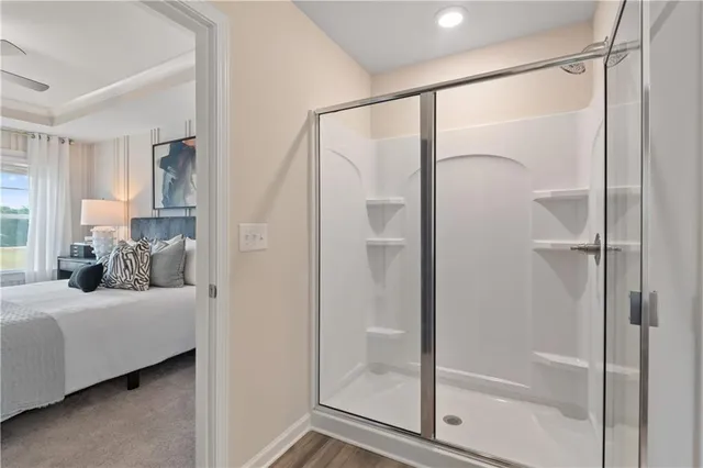 a bedroom with a balcony and a glass door shower