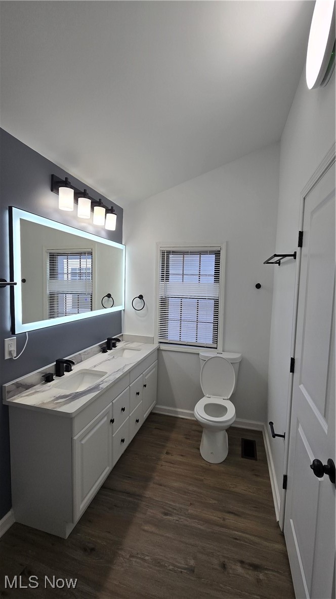 3388 Cedarbrook Road Cleveland, OH 44118 - Photo 9 of 14 Bathroom featuring wood finished floors, toilet, baseboards, and double vanity