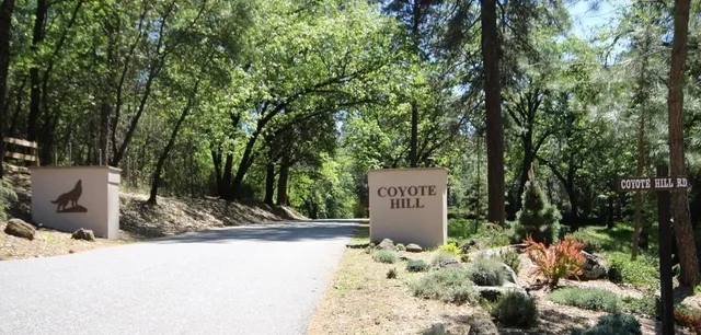 a sign board with a wooden fence