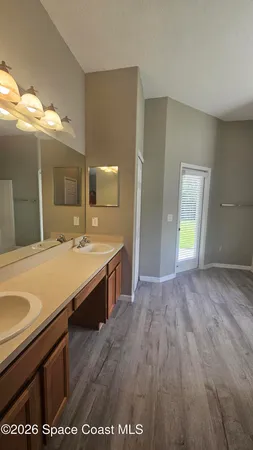 a spacious bathroom with a sink and a mirror