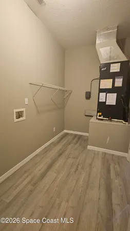 a view of a room with wooden floor
