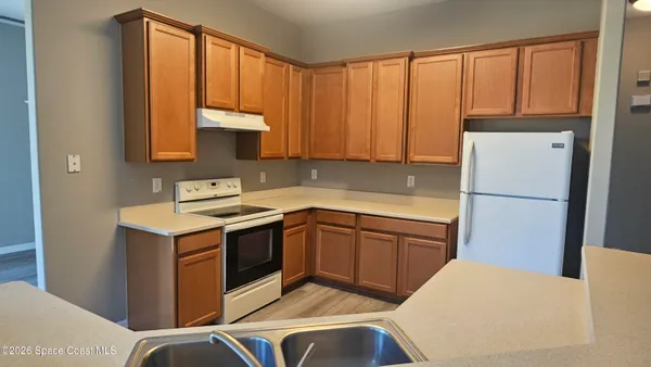 a kitchen with a sink cabinets and appliances