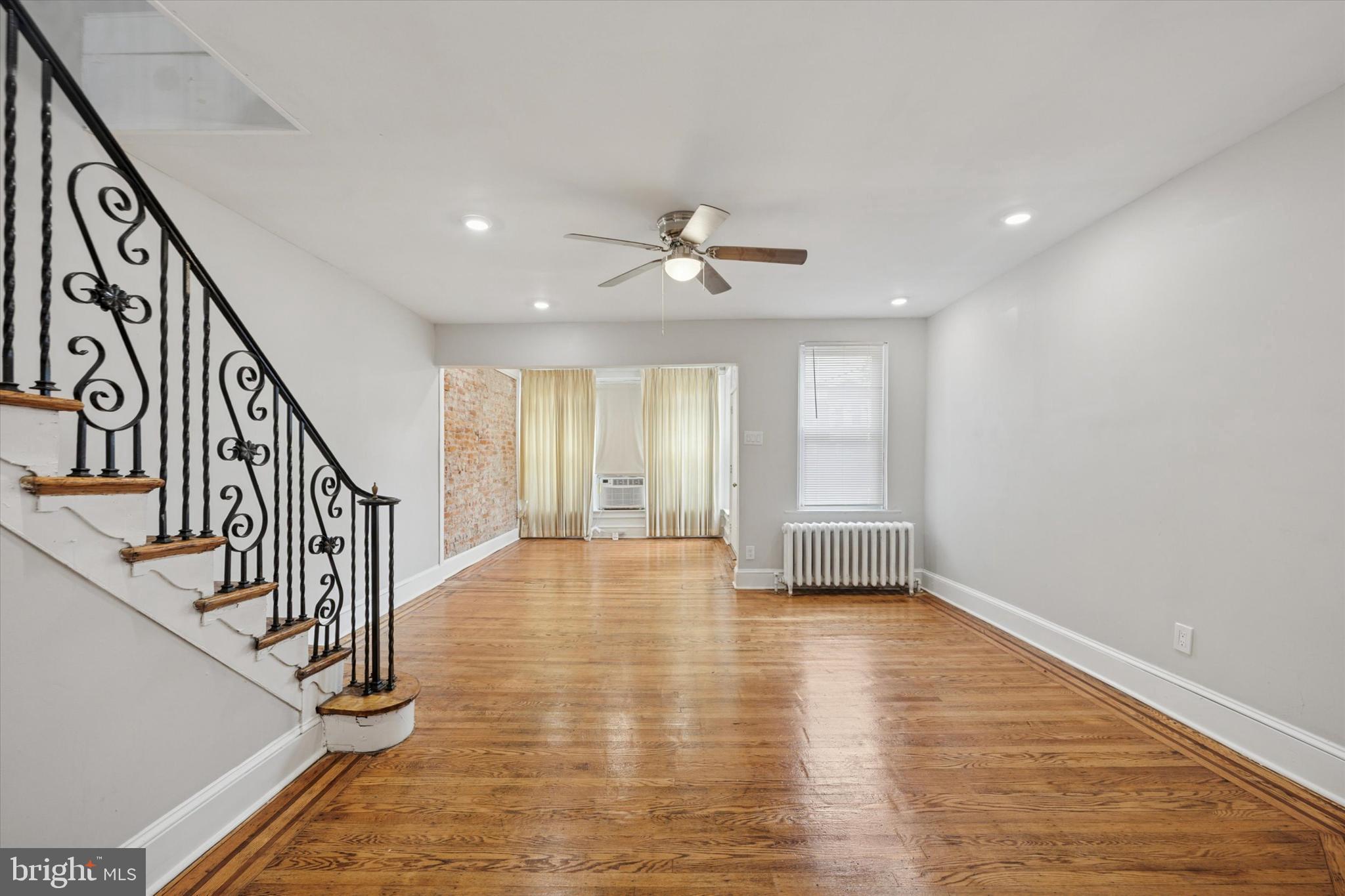 a view of an entryway with wooden floor