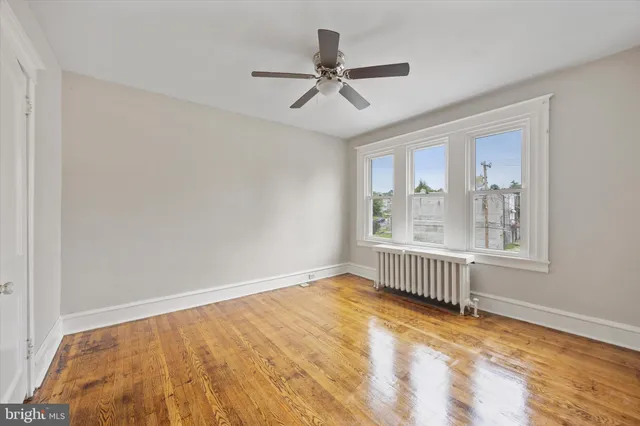 a view of a livingroom with a ceiling fan and window