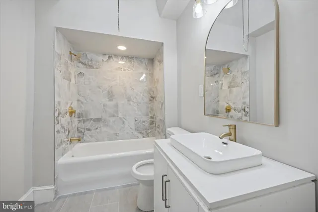 a bathroom with a sink a toilet and a bathtub